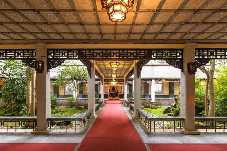 陽明書屋，木構迴廊垂掛宮燈，紅毯通道兩側為日式庭園與雕花欄杆