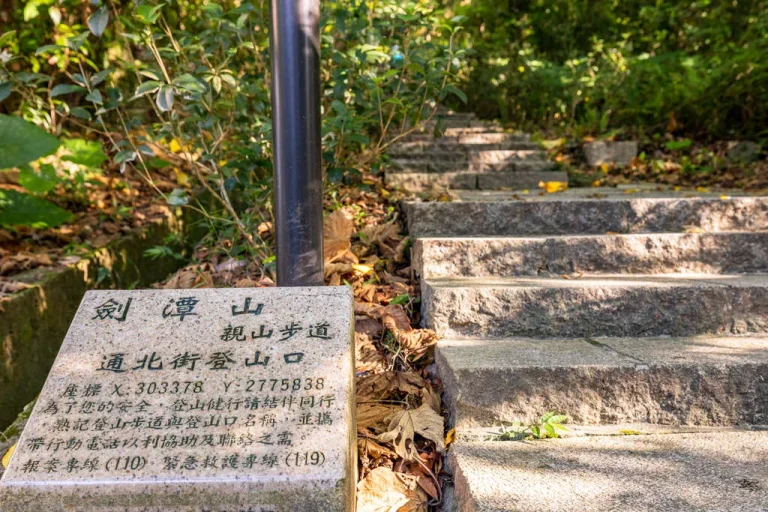 劍潭山親山步道，刻字登山口石碑旁石階向林間向上延伸